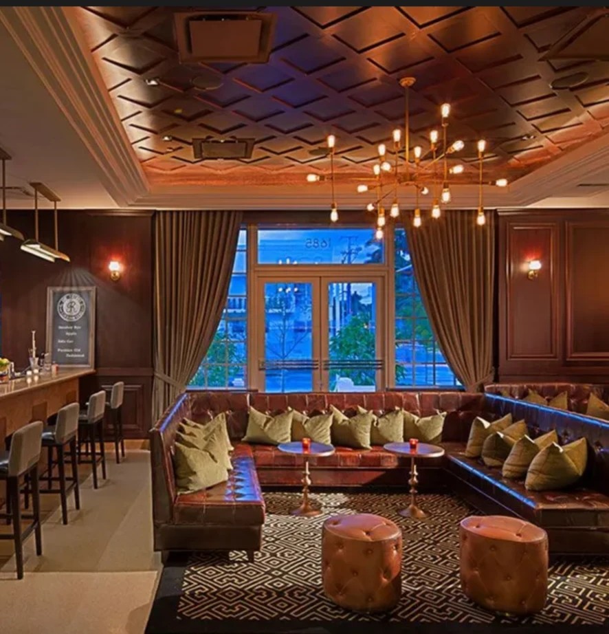 The Regent Cocktail Club lounge seating and coffered ceiling